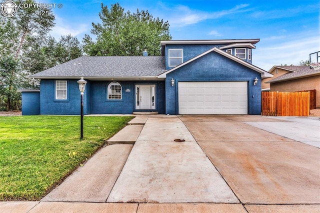 traditional-style house featuring a garage, concrete driveway, fence, a front lawn, and stucco siding