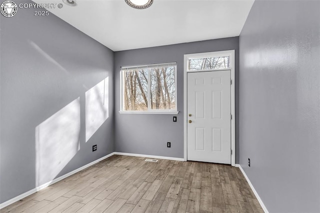 entrance foyer with baseboards and light wood-style floors