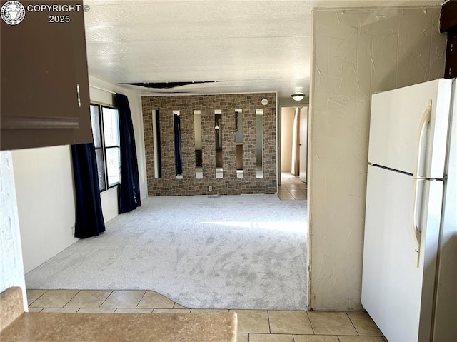 corridor featuring tile patterned flooring, carpet, and a textured ceiling