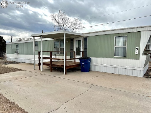 exterior space with a wooden deck and a patio area