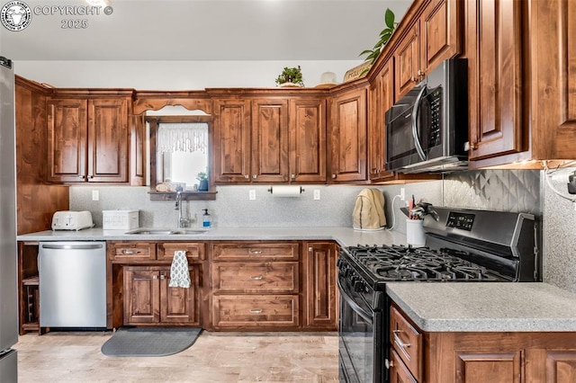 3491 County Road 215th Rd, Westcliffe, CO 81252 - kitchen with appliances with stainless steel finishes, brown cabinetry, tasteful backsplash, and light countertops
