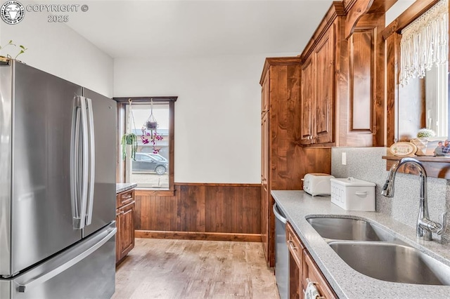 3491 County Road 215th Rd, Westcliffe, CO 81252 - kitchen featuring stainless steel appliances, light wood-type flooring, light stone countertops, wainscoting, and brown cabinetry