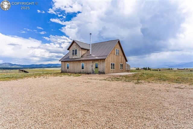 3491 County Road 215th Rd, Westcliffe, CO 81252 - view of side of home with a metal roof, a mountain view, and a patio
