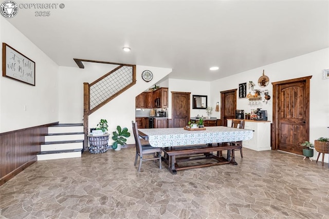 3491 County Road 215th Rd, Westcliffe, CO 81252 - dining area featuring stairway, stone floors, a wainscoted wall, and recessed lighting