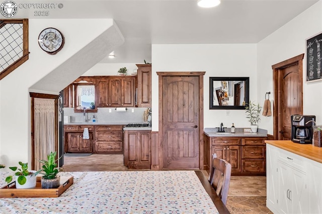 3491 County Road 215th Rd, Westcliffe, CO 81252 - kitchen featuring light countertops, tasteful backsplash, and brown cabinetry