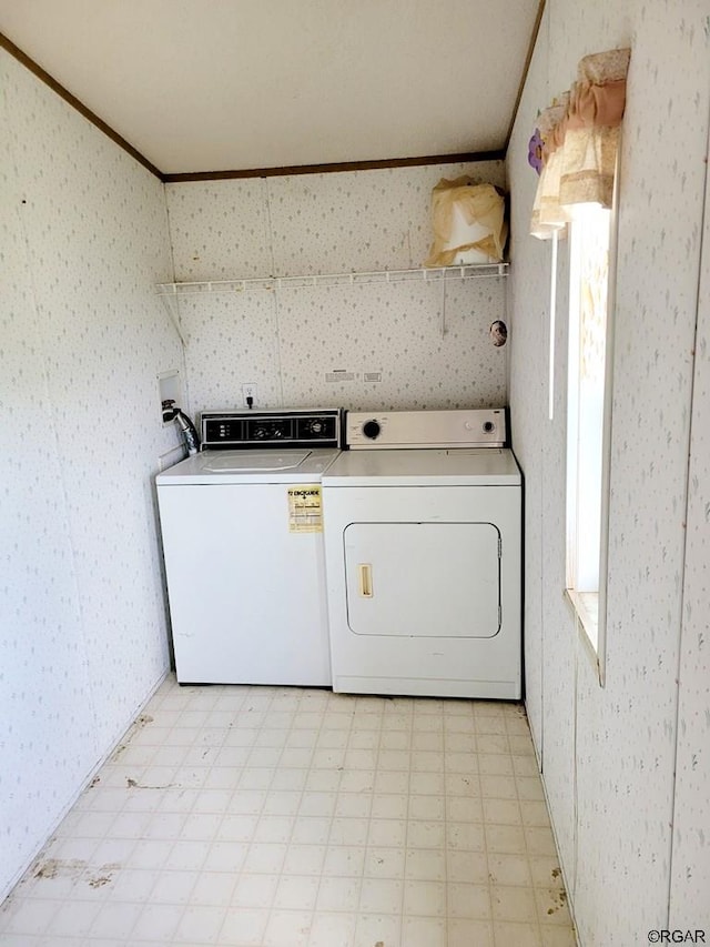 washroom featuring washer and clothes dryer and ornamental molding