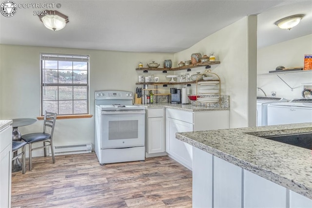 321 County Road 353a, Canon City, CO 81212 - kitchen with electric stove, open shelves, washer and dryer, a baseboard radiator, and light wood finished floors