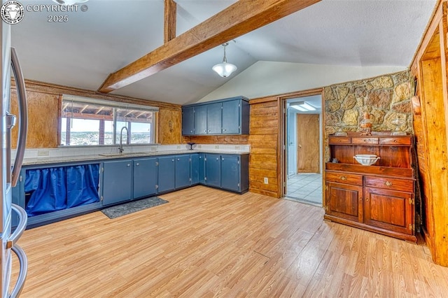 321 County Road 353a, Canon City, CO 81212 - kitchen featuring blue cabinets, light wood finished floors, and freestanding refrigerator