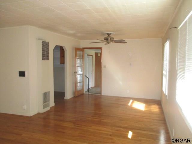 unfurnished room with hardwood / wood-style flooring and ceiling fan