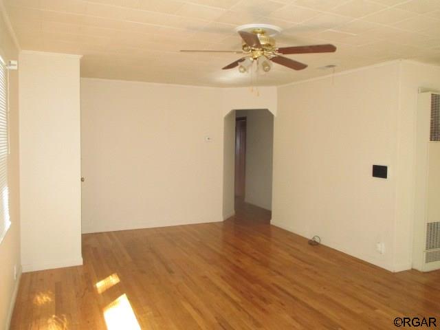 unfurnished room featuring hardwood / wood-style floors and ceiling fan