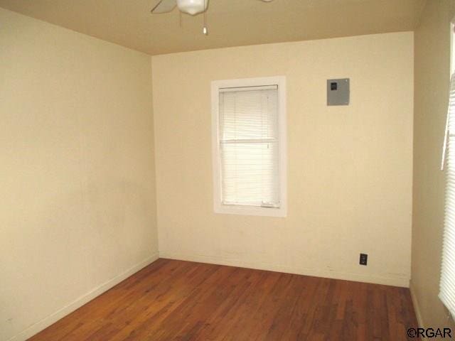 spare room with hardwood / wood-style floors and ceiling fan