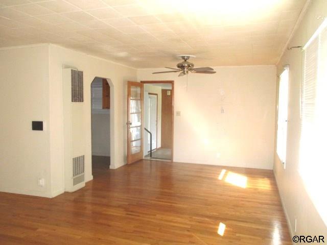 empty room featuring hardwood / wood-style flooring and ceiling fan