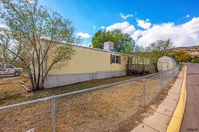 view of home's exterior with a storage shed