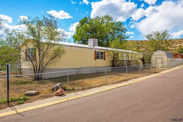 view of home's exterior featuring a storage unit