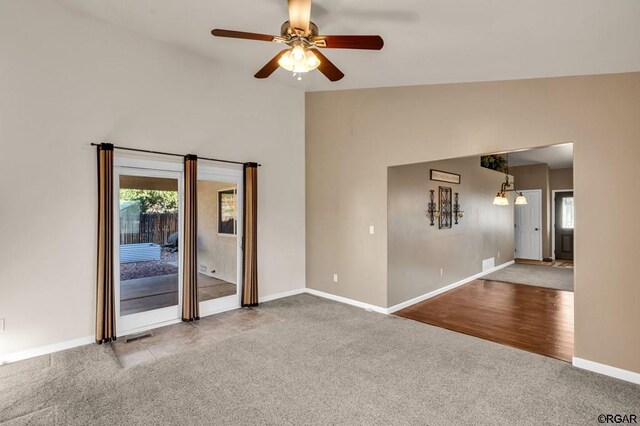 carpeted spare room with lofted ceiling and ceiling fan