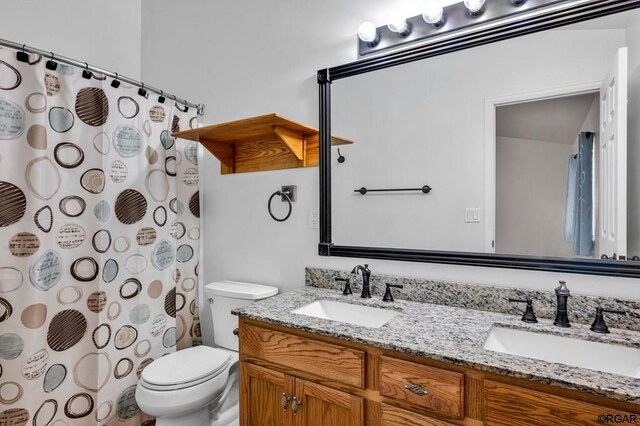 bathroom with vanity, a shower with curtain, and toilet