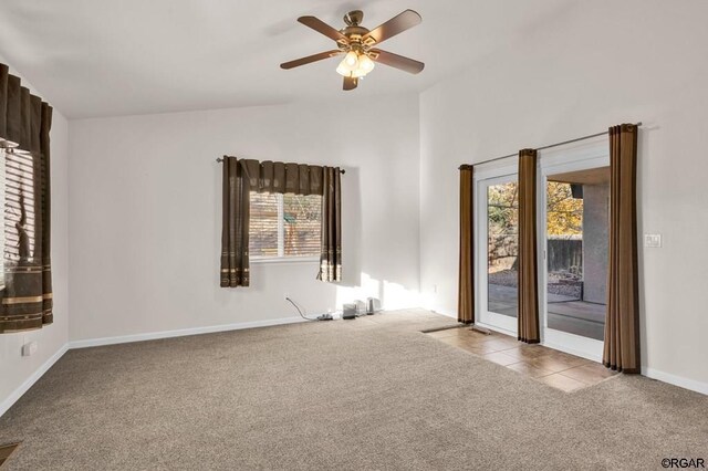 carpeted spare room with ceiling fan