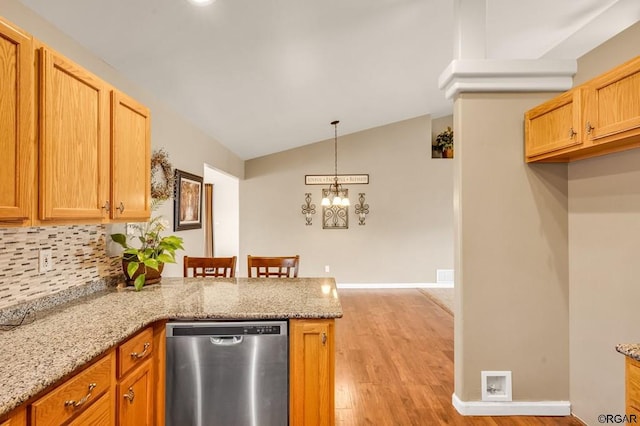 kitchen featuring light stone counters, light hardwood / wood-style flooring, dishwasher, kitchen peninsula, and backsplash