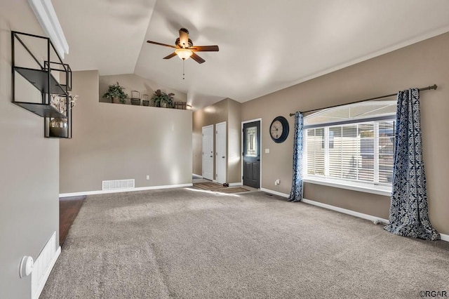 unfurnished living room featuring vaulted ceiling, ceiling fan, and carpet flooring