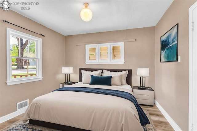 bedroom with light wood-style flooring and baseboards