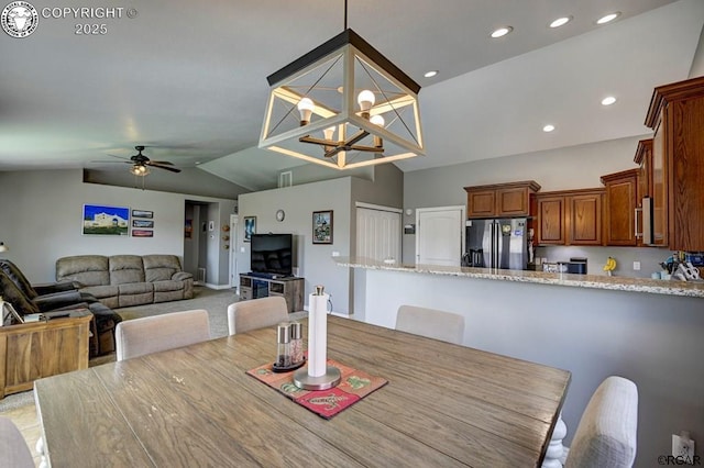 dining room featuring recessed lighting, ceiling fan with notable chandelier, and vaulted ceiling