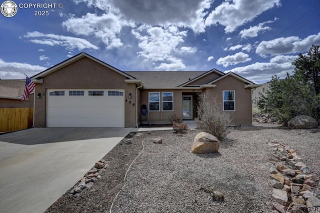 single story home featuring stucco siding, concrete driveway, a garage, and fence