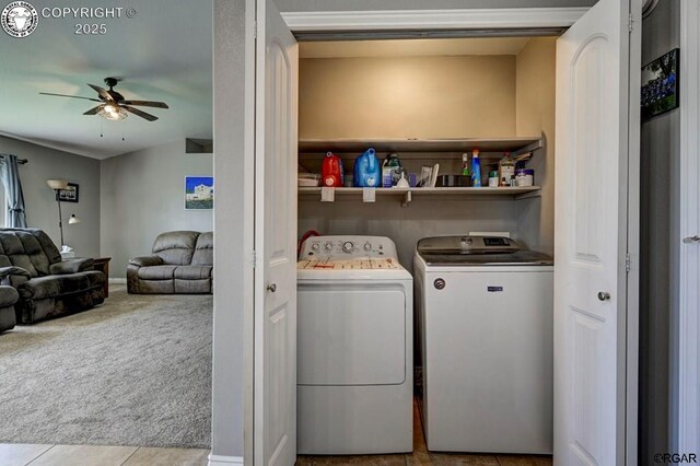 clothes washing area with a ceiling fan, carpet, laundry area, tile patterned flooring, and independent washer and dryer