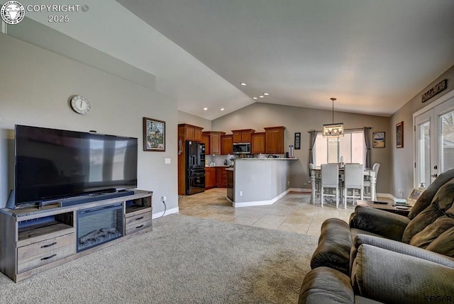 living room featuring baseboards, a chandelier, light colored carpet, lofted ceiling, and light tile patterned floors