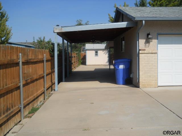 view of vehicle parking featuring a carport and a garage