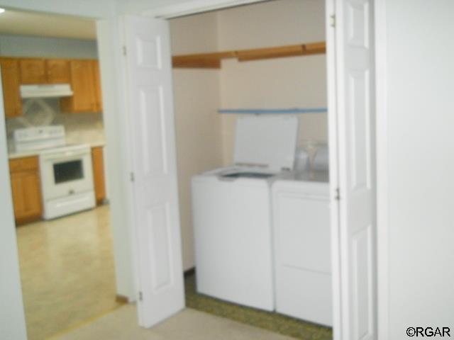 clothes washing area with washer and clothes dryer