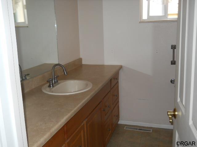 bathroom featuring vanity and tile patterned flooring