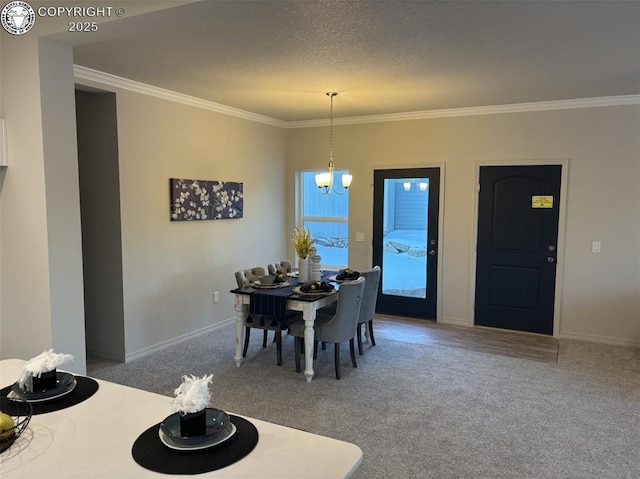 dining room featuring crown molding, carpet, a notable chandelier, and a textured ceiling