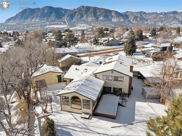 snowy aerial view with a mountain view