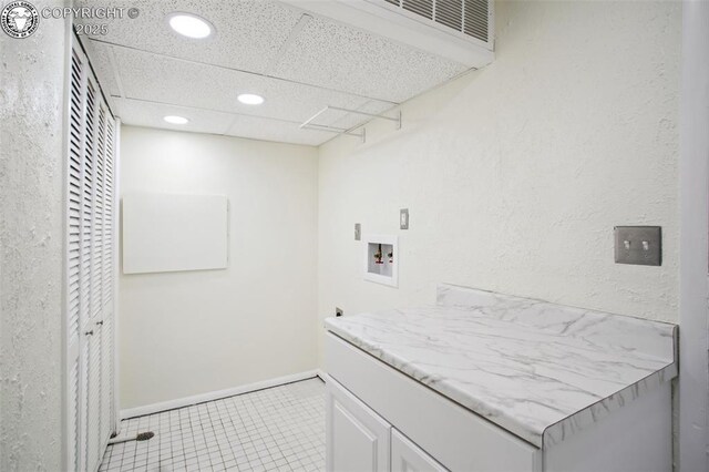 clothes washing area featuring cabinets and washer hookup