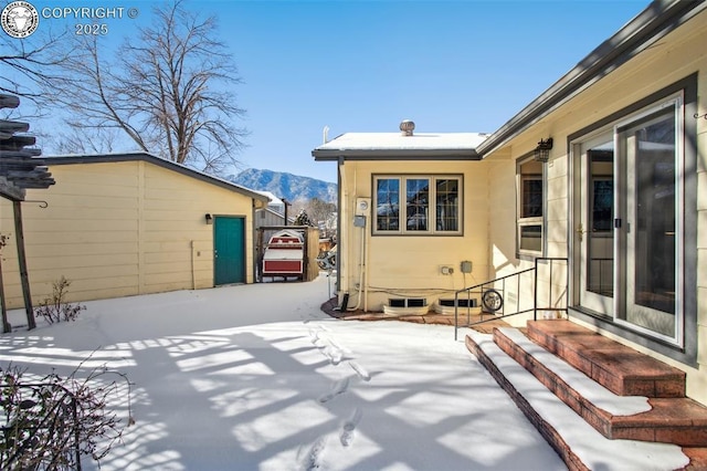 snow covered patio featuring a mountain view