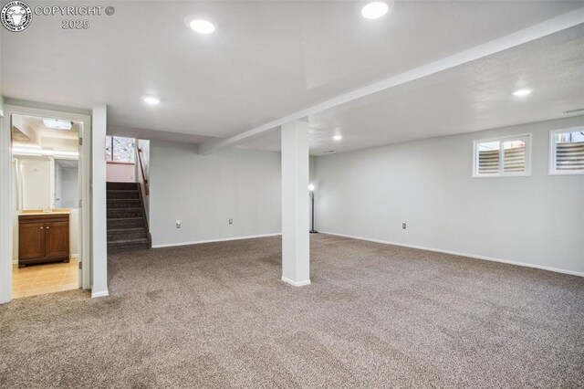 basement with light carpet and a healthy amount of sunlight