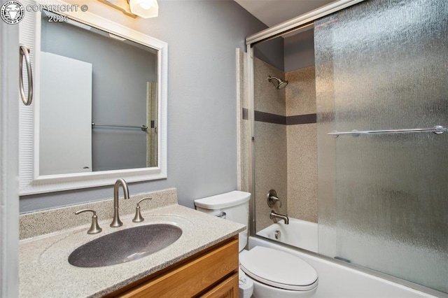 full bathroom with toilet, vanity, and bath / shower combo with glass door