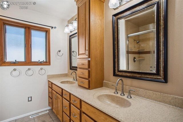 bathroom with tile patterned floors, vanity, and an enclosed shower