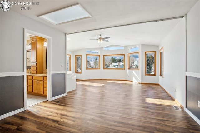 unfurnished living room featuring ceiling fan, wood-type flooring, and vaulted ceiling