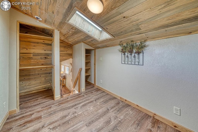 820 Little Horn Dr, Westcliffe, CO 81252 - below grade area featuring wooden ceiling, baseboards, a textured wall, and wood finished floors