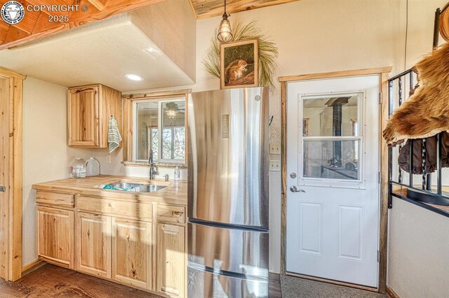 820 Little Horn Dr, Westcliffe, CO 81252 - kitchen with dark wood finished floors, freestanding refrigerator, light brown cabinets, and a sink