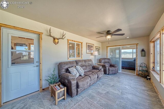 820 Little Horn Dr, Westcliffe, CO 81252 - living area featuring baseboards, a ceiling fan, and stone finish floor