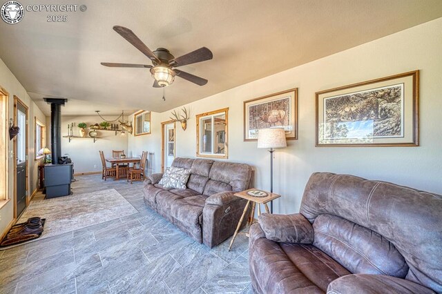 820 Little Horn Dr, Westcliffe, CO 81252 - living room featuring a wood stove and a ceiling fan