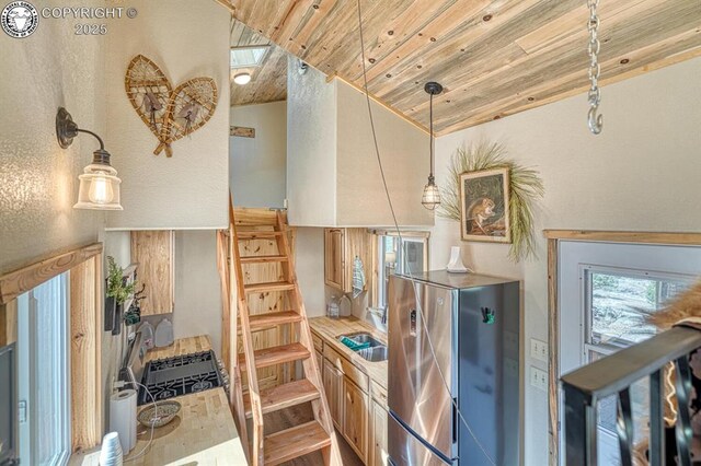 820 Little Horn Dr, Westcliffe, CO 81252 - kitchen with lofted ceiling, wooden ceiling, a sink, freestanding refrigerator, and hanging light fixtures