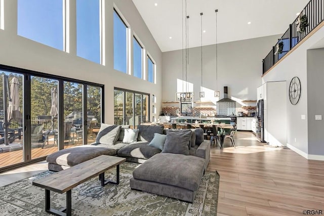 living room with wood-type flooring and a high ceiling