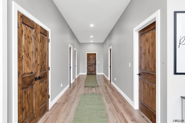 corridor with light hardwood / wood-style flooring