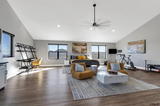 living room featuring ceiling fan, dark hardwood / wood-style floors, high vaulted ceiling, and a wealth of natural light