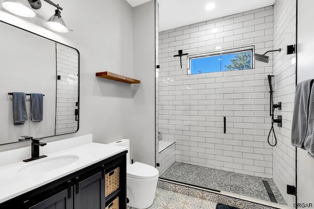 bathroom featuring vanity, a shower with shower door, tile patterned floors, and toilet