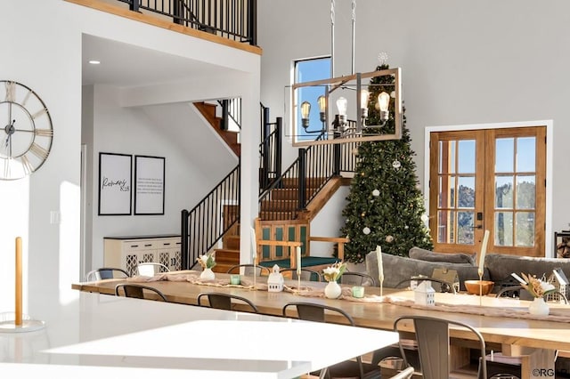 kitchen with a notable chandelier, french doors, and a high ceiling