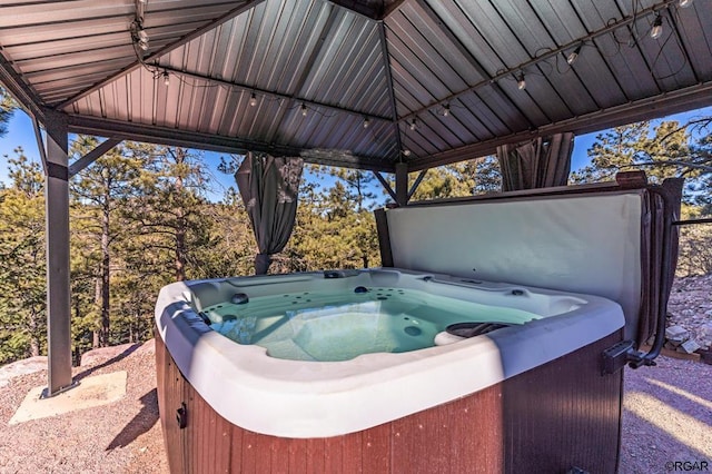 view of patio featuring a hot tub and a gazebo